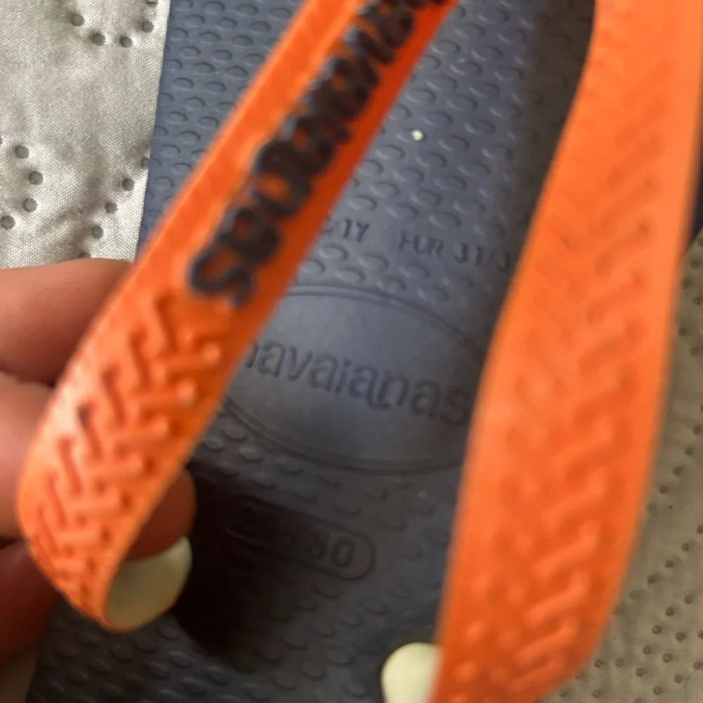 Havana’s flip flops size 29/30 (11-12). Navy base w/orange strap. Great shape!